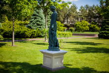 Antique Statue Of A Girl In The Park. 