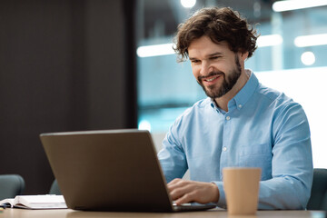 Poster - Handsome mature businessman working with laptop pc at his desk in office, blank space