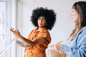 Wall Mural - Young businesswomen brainstorming in an office