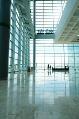 Canvas Print - Vertical shot of a modern interior of an airport with glass window panels