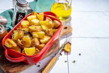 Slices Of Fried Or Baked Potato Wedges With Herbs And Spices In Frying Pan Copy Space