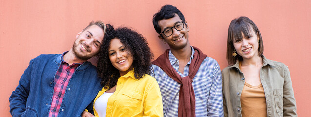 Horizontal banner or header with multiracial friends group having fun at wall on university college campus - Diverse culture students portrait celebrating outside