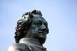 Closeup shot of the head of Goethe from the famous Goethe -Schiller Monument against a cloudless sky