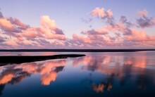 Beautiful Seascape With A Purple Cloudy Sky Reflected In The Water
