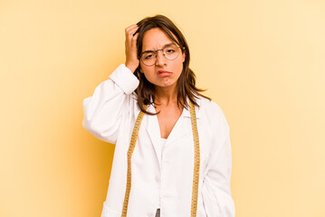 Wall Mural - Young nutritionist hispanic woman isolated on yellow background being shocked, she has remembered important meeting.