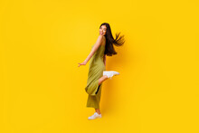Full Size Profile Portrait Of Cheerful Adorable Thai Person Toothy Smile Stand One Foot Isolated On Yellow Color Background