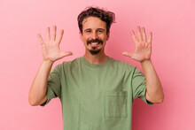 Young Caucasian Man Isolated On Pink Background Showing Number Ten With Hands.