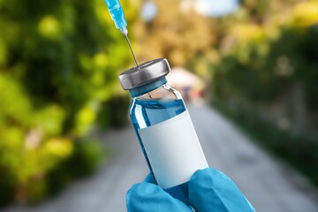 Wall Mural - A vial of vaccine for Monkeypox virus, on outdoor background