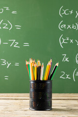 Poster - Image of cup with crayons over mathematical formulas on black board