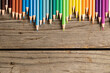 Composition of colorful crayons on wooden background