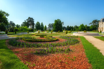 Beautiful garden of Festetics Palace with flowers and green grass and trees on a sunny summer day, Keszthely, Zala, Hungary. Outdoor travel background