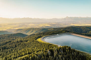 Hydroelectric power plant Cierny Vah. Sunset in Slovakia, Liptov. High Tatras scenery. Monumental peaks over water level