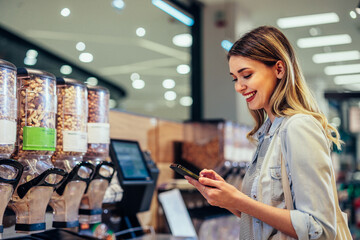 Wall Mural - Young woman at grocery store