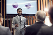 Cheerful excited young African-American sales expert in gray suit standing in front of audience and holding clipboard while presenting graphs