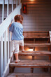 cute little baby girl going upstairs the wooden porch