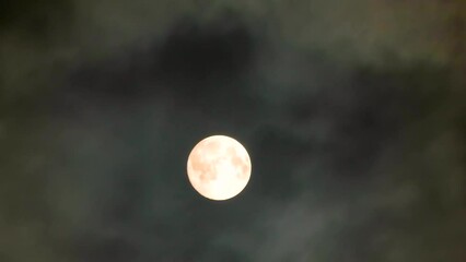 Wall Mural - Moon in the clouds. Mystery of the night sky. Clouds fly in front of the Moon