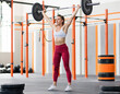 © photology1971 - Fit female weightlifter doing snatch exercise