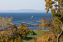 Close-up View Of Lake Champlain, Its Boat Docking Slips And Lighthouse As Seen From Burlington, Vermont. The Adirondack Mountains Flank The Lake On The West Side.