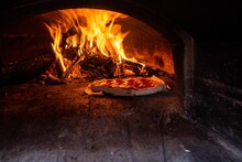 Italian Pizza In A Traditional Wood-fired Stone Oven