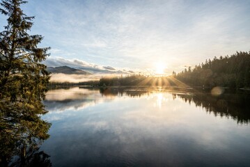 Wall Mural - beautiful sunset scenery with clouds reflecting in the water at port renfrew, bc, canada