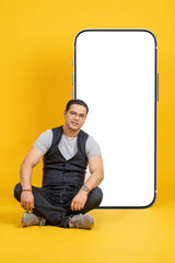 Poster - Mobile template. Young man with phone. Big smartphone behind man. Cellphone with white screen. Mobile phone it with copy space. Phone number for your website. Smartphone template. Cellphone on yellow