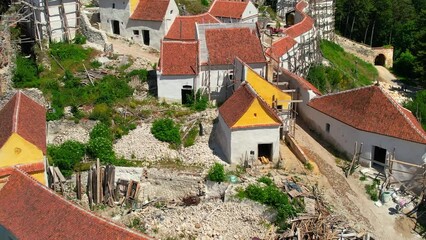 Wall Mural - Aerial drone view of The Rasnov Fortress in Romania. Medieval fortress and construction work inside it, Carpathians