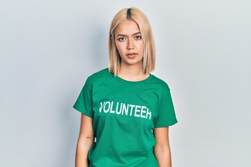 Poster - Beautiful blonde woman wearing volunteer t shirt looking sleepy and tired, exhausted for fatigue and hangover, lazy eyes in the morning.