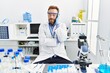 © Krakenimages.com - Middle age man working at scientist laboratory thinking looking tired and bored with depression problems with crossed arms.