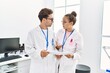 © Krakenimages.com - Man and woman wearing scientist uniform working at laboratory