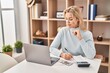 © Krakenimages.com - Young blonde woman sitting on table working at home