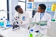 © Krakenimages.com - Man and woman scientists using microscope writing on notebook at laboratory