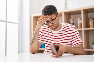 Poster - African american man holding empty wallet sitting on desk at home