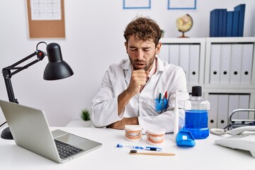 Canvas Print - Young hispanic dentist man working at medical clinic feeling unwell and coughing as symptom for cold or bronchitis. health care concept.