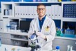 © Krakenimages.com - Young hispanic man scientist smiling confident working at laboratory