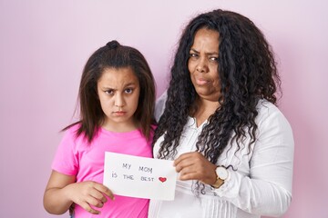 Sticker - Mother and young daughter holding my mom is the best banner skeptic and nervous, frowning upset because of problem. negative person.