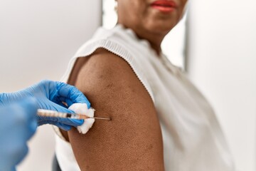 Poster - Senior african american woman patient having vaccination at clinic