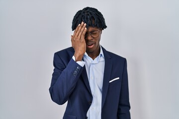 Poster - Young african man with dreadlocks wearing business jacket over white background yawning tired covering half face, eye and mouth with hand. face hurts in pain.