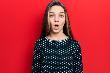 Sticker - Young brunette girl wearing casual sweater scared and amazed with open mouth for surprise, disbelief face