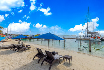 Wall Mural - Serene turquoise Isla Mujeres beaches and sandy sea shore and beach bars for fun and beach parties.