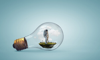 Wall Mural - spaceman inside light bulb . mixed media