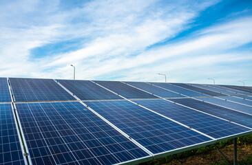 Photovoltaic solar power panel on dramatic sunset blue sky background, green clean Alternative power energy concept.