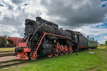 Wall Mural - An old steam locomotive rests on the siding.