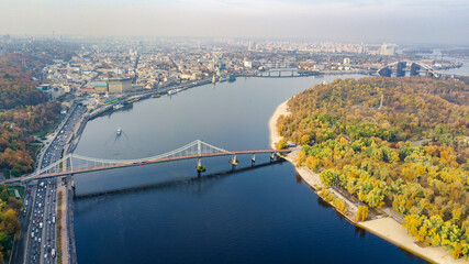 Wall Mural - Kyiv skyline aerial drone view, historical Podil district, Dnipro river and bridge cityscape from above, city of Kiev in autumn, Ukraine
