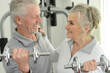 © aletia2011 - Elderly couple exercising in the gym with dumbbells