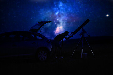 Wall Mural - silhouette of a man, car, telescope and countryside under the starry skies.