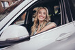 Photo of cheerful pretty lady sitting car driver seat look through window toothy smile