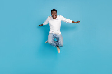 Wall Mural - Full body photo of excited crazy man arms flight freedom good mood isolated on blue color background