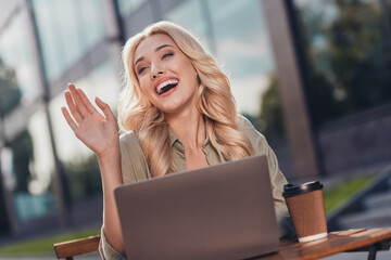 Poster - Portrait of attractive cheerful wavy haired girl using netbook waving hi hello waiting friend in complex outdoors