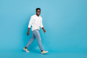 Poster - Full body profile photo of positive cheerful person walking toothy smile isolated on blue color background