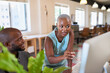 © Meeko Media - A Black woman advises her coworker while they both look at computer screen